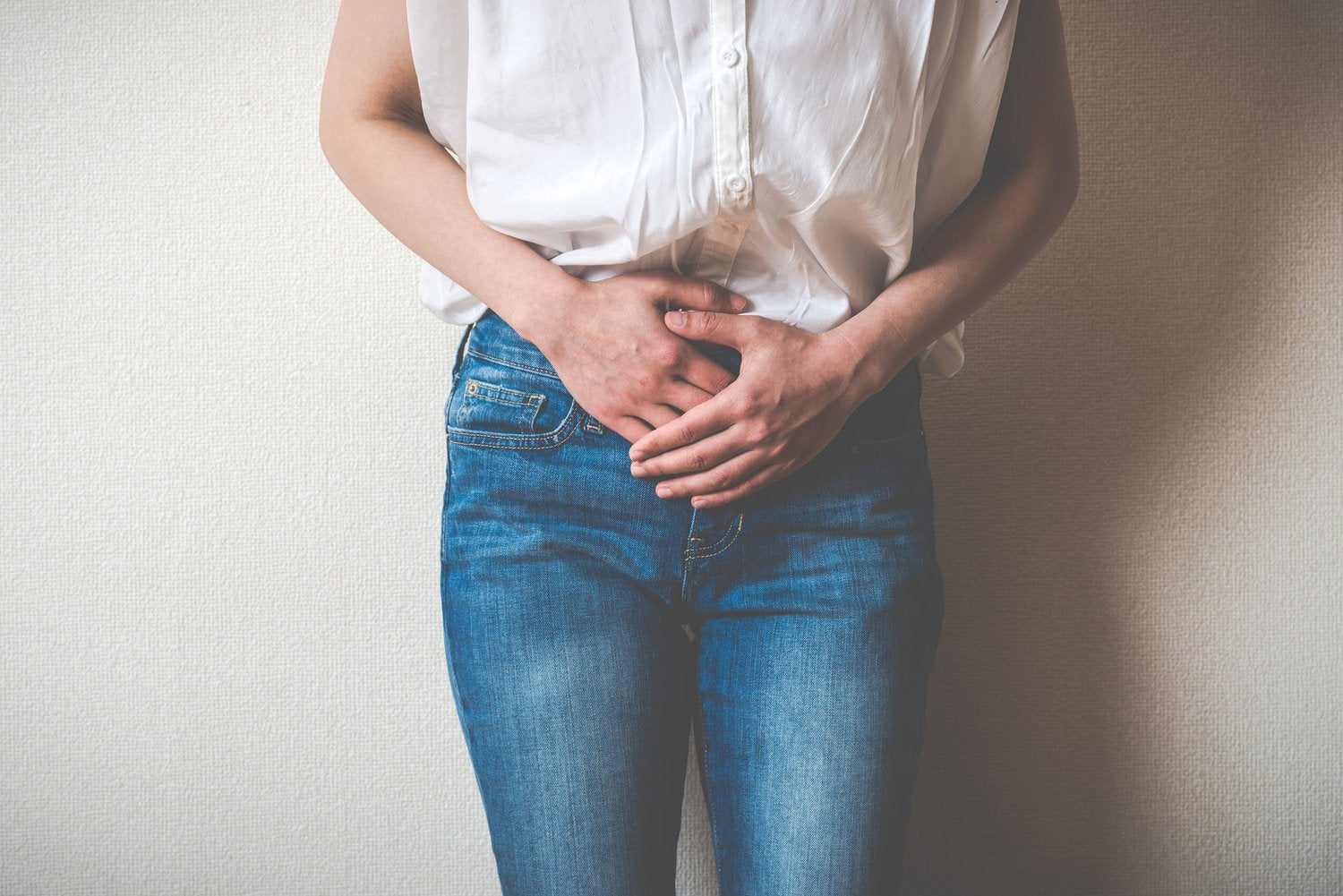 Women holding lower abdomen