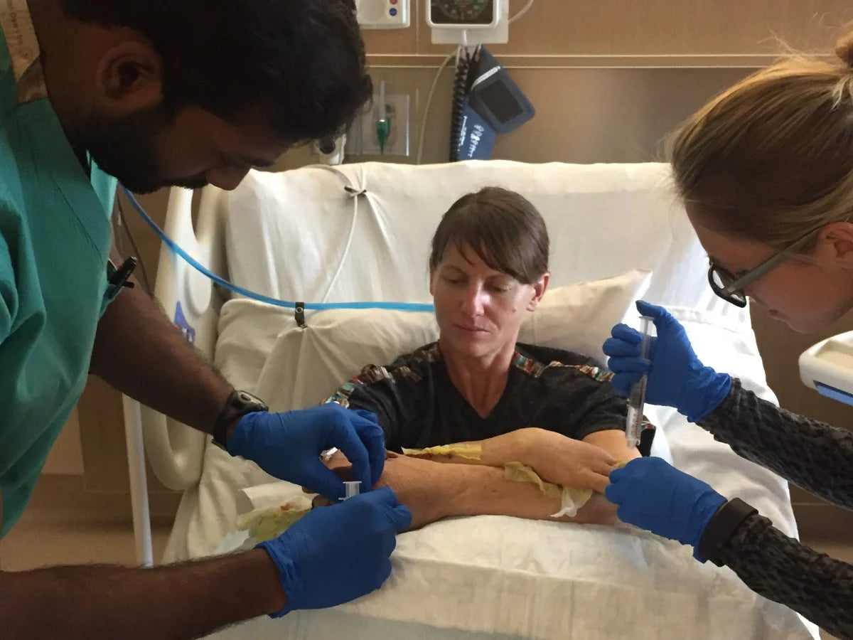 Melissa Strong, arms crossed in the I Dream of Jeanie position, receives care from providers at UCH. Her thumbs remained attached to her forearms for three weeks.