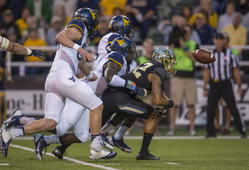 Baylor’s Levi Norwood (42) fumbles a punt that West Virginia recovers for a touchdown during the first quarter at Floyd Casey Stadium.