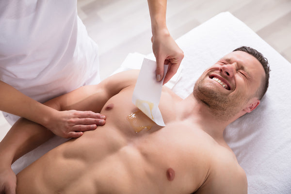 Man Waxing His Chest Hair