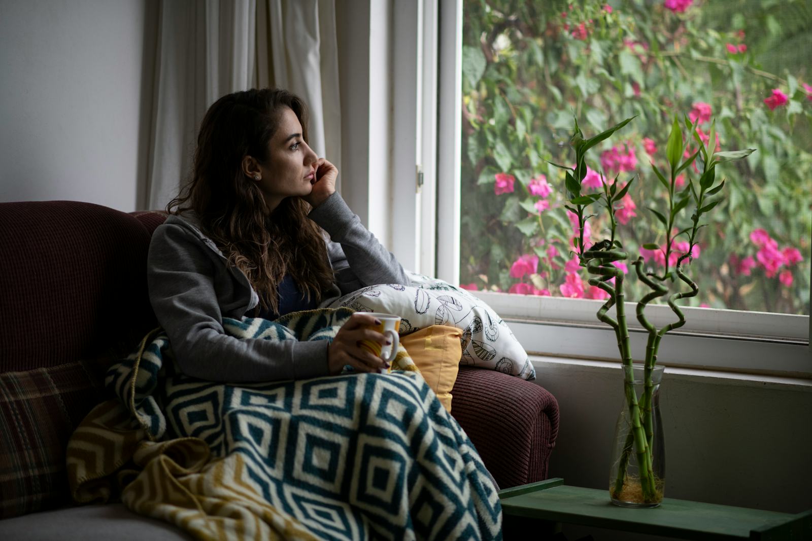 Depressed Woman Sitting by Window