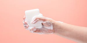 Hand Gripping a White Soap