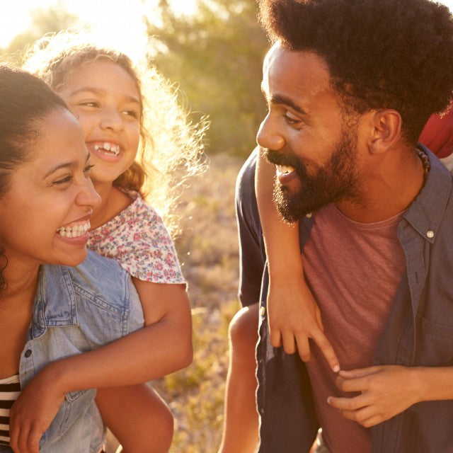 Happy, healthy family smiles at each other