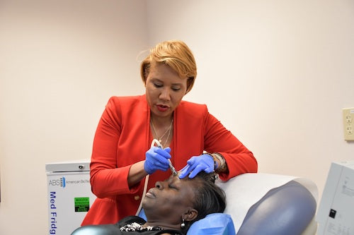 Vikisha Fripp, a plastic and reconstructive surgeon, conducts a microdermabrasion procedure on Leslie Smalls at the University of Maryland Capital Region Health office in Bowie on Jan. 31. (Anthony Tilghman/The Washington Informer)