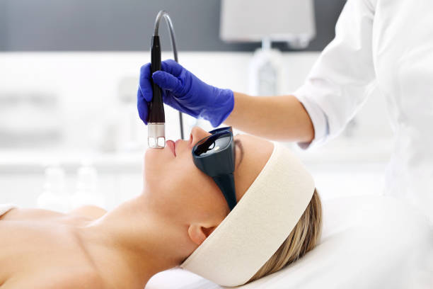 A woman in a beauty salon during a laser treatment.