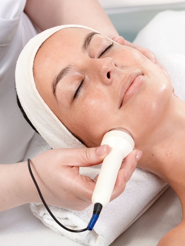 A woman receiving a photo facial at a spa.